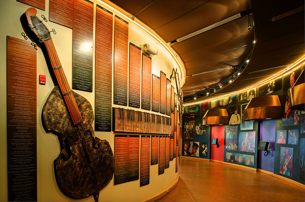 A large guitar and several signs hang on a wall exhibit at Red Rocks Amphitheatre & Visitor Center, Morrison, CO