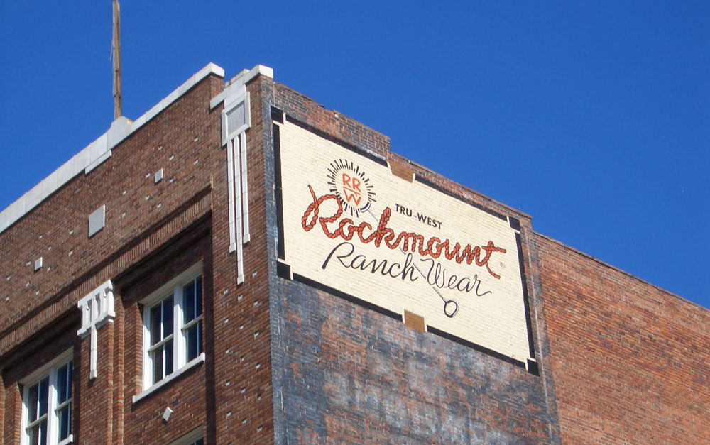 Exterior of a brick storefront against a blue sky