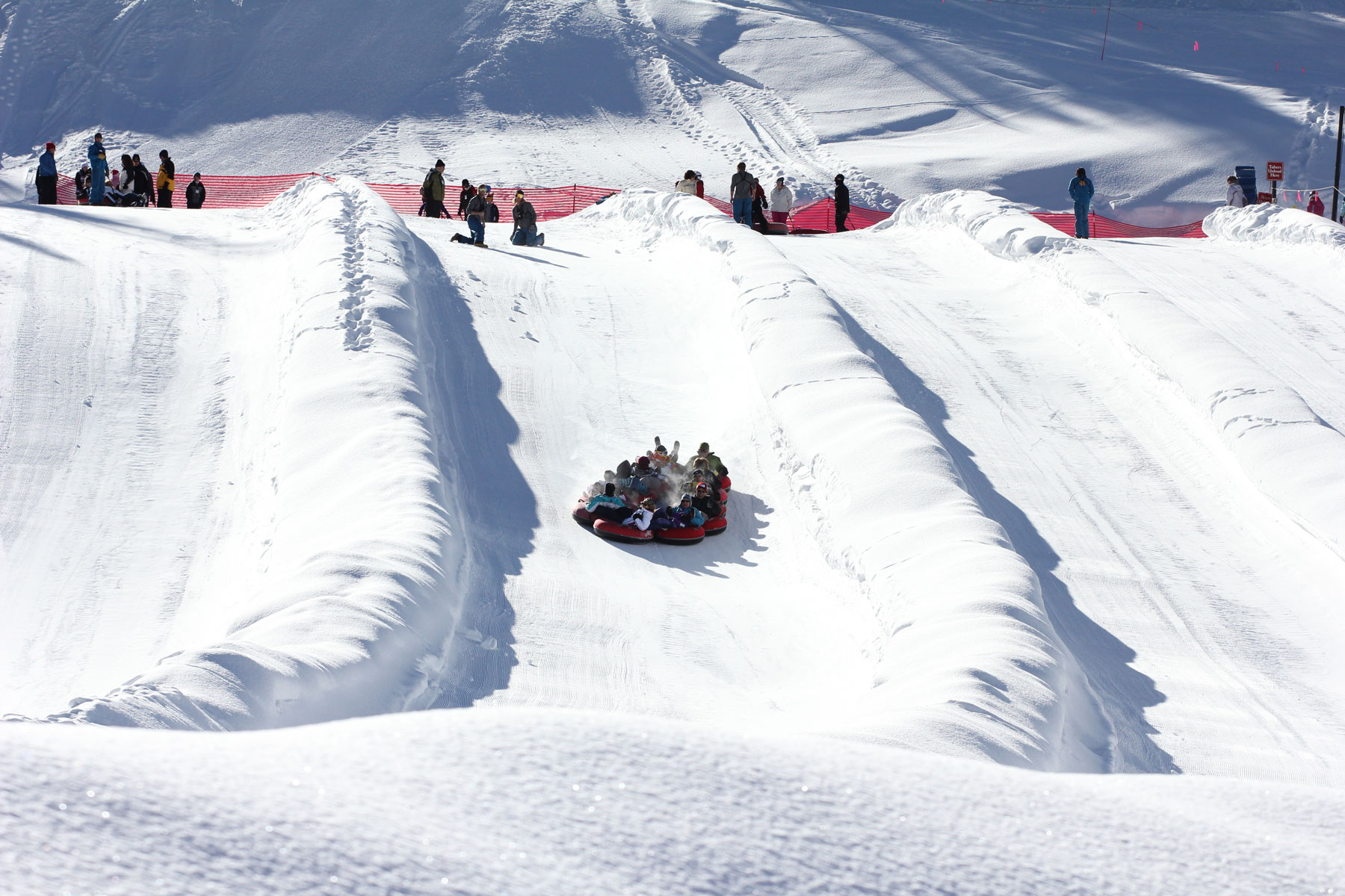 A snow tube races down a snowy lane