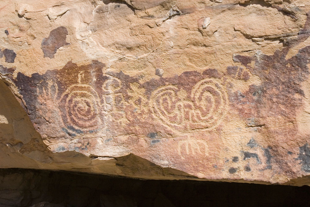 A tan-rock covered in Petroglyphs in  Ute Tribal Park in Towaoc.