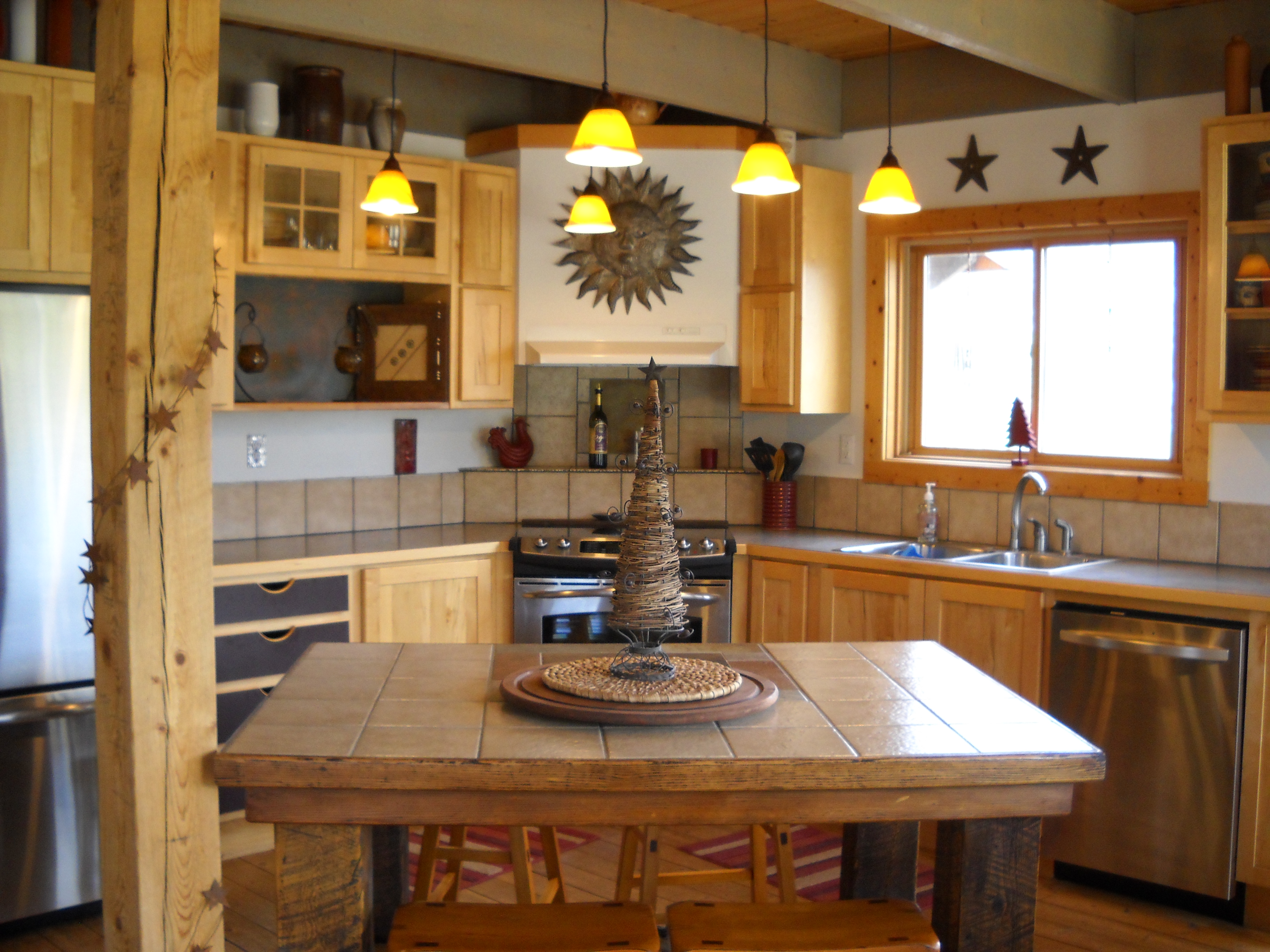 the gourmet kitchen has stainless appliances, an island, a walk-in pantry and a window over the sink for wildlife and nature viewing. photo