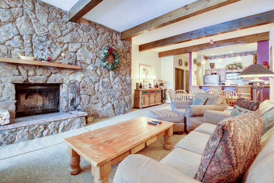 a spacious living room awaits you at the beaver creek west condo. sofa and chair seating are arranged to make the most of the wood burning fireplace and tv with cable and dvd player. photo