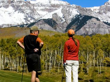 Discussing their next shot as well as the scenery during a golf outing in Colorado