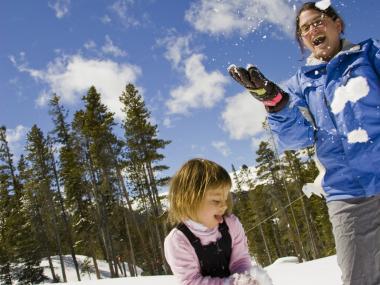 A family plays in snow at Winter Park Ski Area