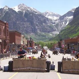 Colorado Top Chef Episode 11 Top Chef contestants cooking in the middle of the road in downtown Telluride with the mountains in the background