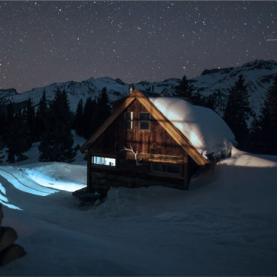 Blog hero A snowy cabin reflected in the moonlight