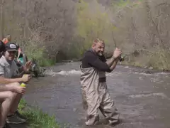 Do Colorado Right: Hire a Local Guide Man fishing along a crowded river accidentally hitting people with his pole