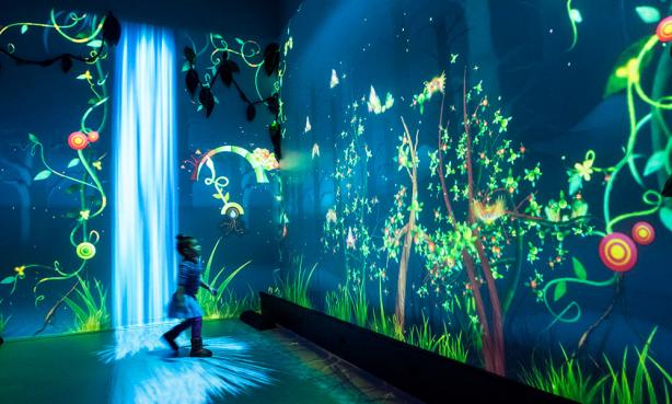 Girl in science museum with flowers painted on the walls