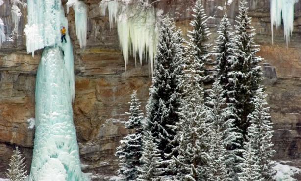 A climber scales a frozen waterfall near Vail.