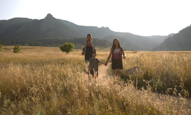 Family hiking Chautauqua Trail at dusk.