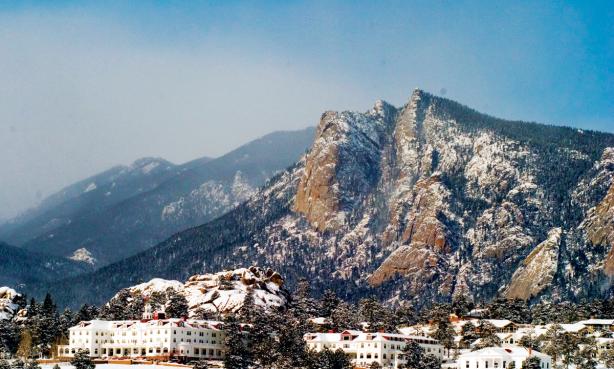 The Stanley Hotel in Estes Park blanketed in snow with the mountains in the background