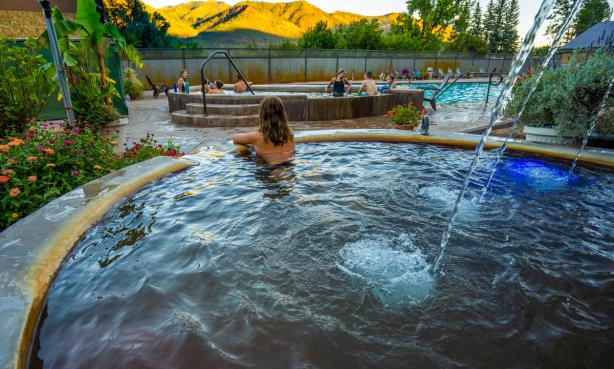 Person soaks in a pool while looking at the mountains at Durango Hot Springs Resort & Spa