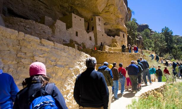 people looking at the cliff dwellings in mesa verde national park