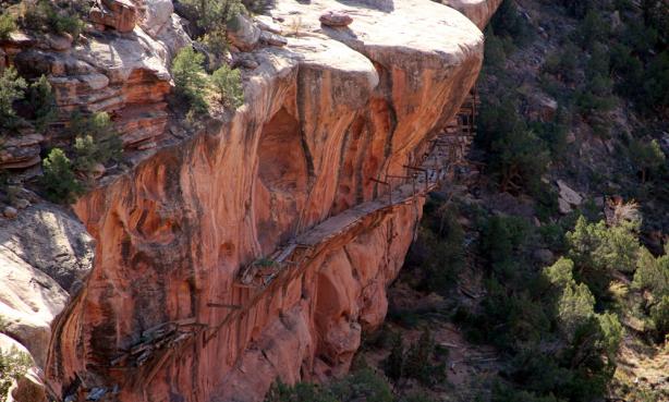 Historical hanging flume structure built on the side of a cliff