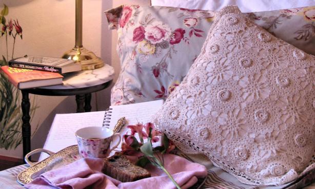 Breakfast tray and journal on a bed