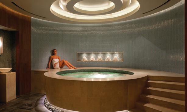 Woman lounging next to a hot tub