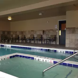 relax in the indoor pool and spa at the holiday inn express & suites near winter park photo