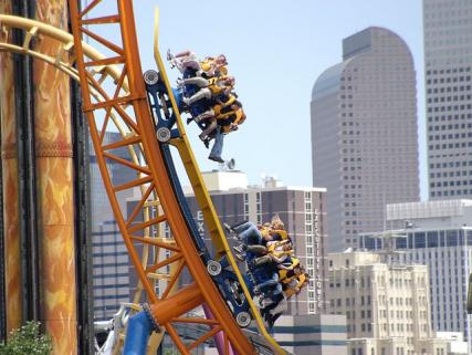 A roller coaster ride at Elitch Gardens Theme Park with downtown Denver in the background - Denver, CO