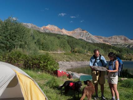 Backpackers set up camp and read a map at Trout Lake - near Telluride, CO