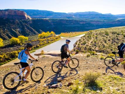 Mountain bikers search for singletrack above the Colorado River - Fruita, CO