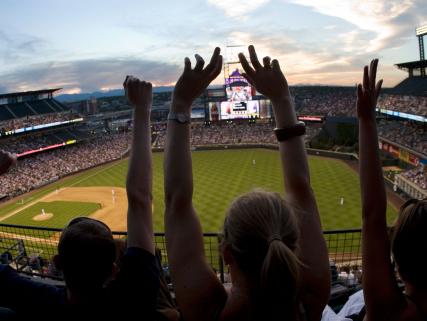 Fans cheer the Colorado Rockies baseball team at Coors Field - Denver, CO