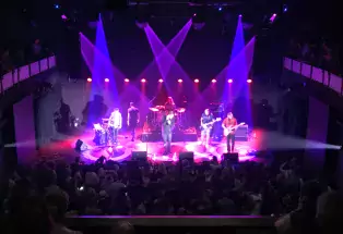 Purple lights shining on a band on a stage