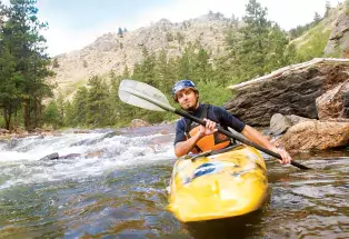 Kayaking along the Cache la Poudre River near Fort Collins Kayaking along the Cache la Poudre River near Fort Collins