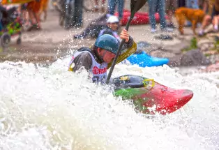Kayaker paddling through a rapid