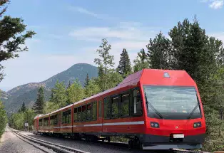 New Pikes Peak train with mountains in the background