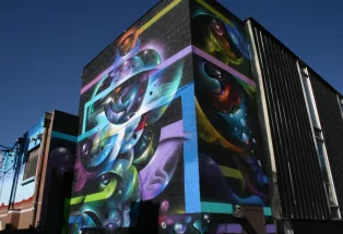 A colorful mural on the side of a building in Denver's RiNo neighborhood