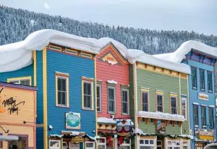 Downtown Crested Butte's historic storefronts covered in winter snowdrifts