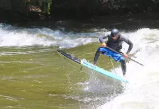 Paddleboarder ripping a wave on the Arkansas