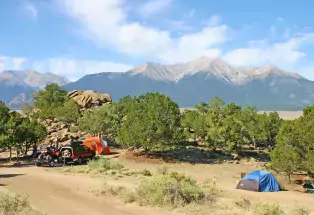 Tents in Buena Vista surrounded by mountain peaks.