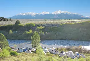Cluster of white tents near the Arkansas River.