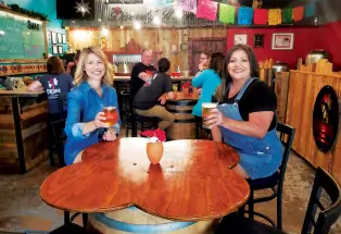 Two people drinking beer at Atrevida Beer Company in Colorado Springs