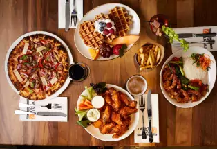 Table with plates of many cuisines