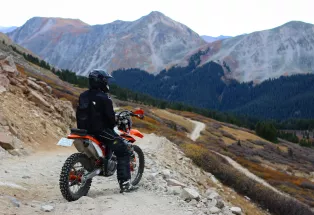 Motorcycle rider admires the mountain scenery from Tincup Pass near Buena Vista
