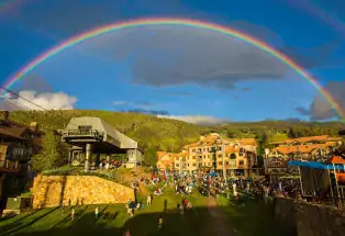A rainbow over a bustling ski area