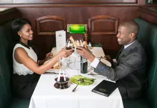 Man and woman clinking wine glasses.