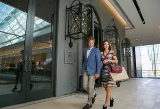 Man and woman walk through a building