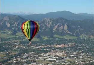 colorful balloon rising over the foothills.