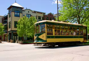 Trolley strolling through the streets of a city.