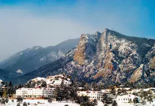 The Stanley Hotel in Estes Park blanketed in snow with the mountains in the background