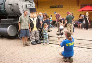 A family gets their picture taken at the Colorado Railroad Museum in Golden in front of a train