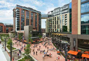 McGregor Square bustles with restaurants, shops, a hotel, pedestrians and more on a sunny day