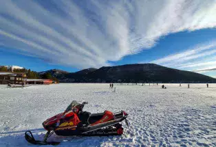 Snowmobiling on frozen Grand Lake in Colorado