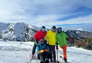 A group of skiers with disabilities and instructors on top of a mountain near Aspen Colorado