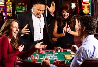 A group of people at a gaming table at Sky Ute Casino in Colorado