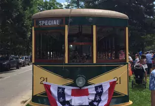 The Birney Car 21 Trolley is a restored 1919 Fort Collins streetcar. It's yellow with dark green accents.
