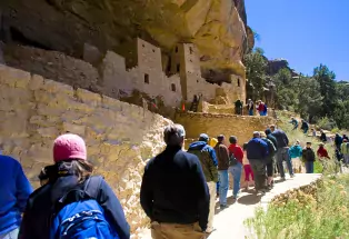 people looking at the cliff dwellings in mesa verde national park